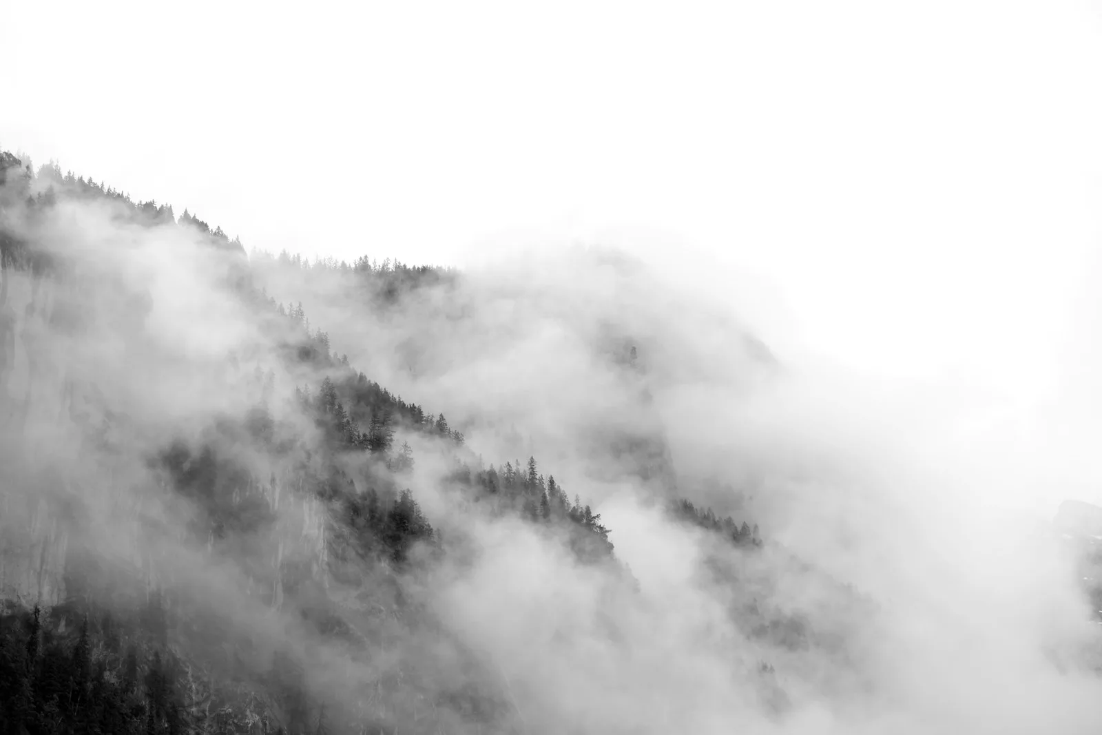 Alpine peaks receding into morning haze